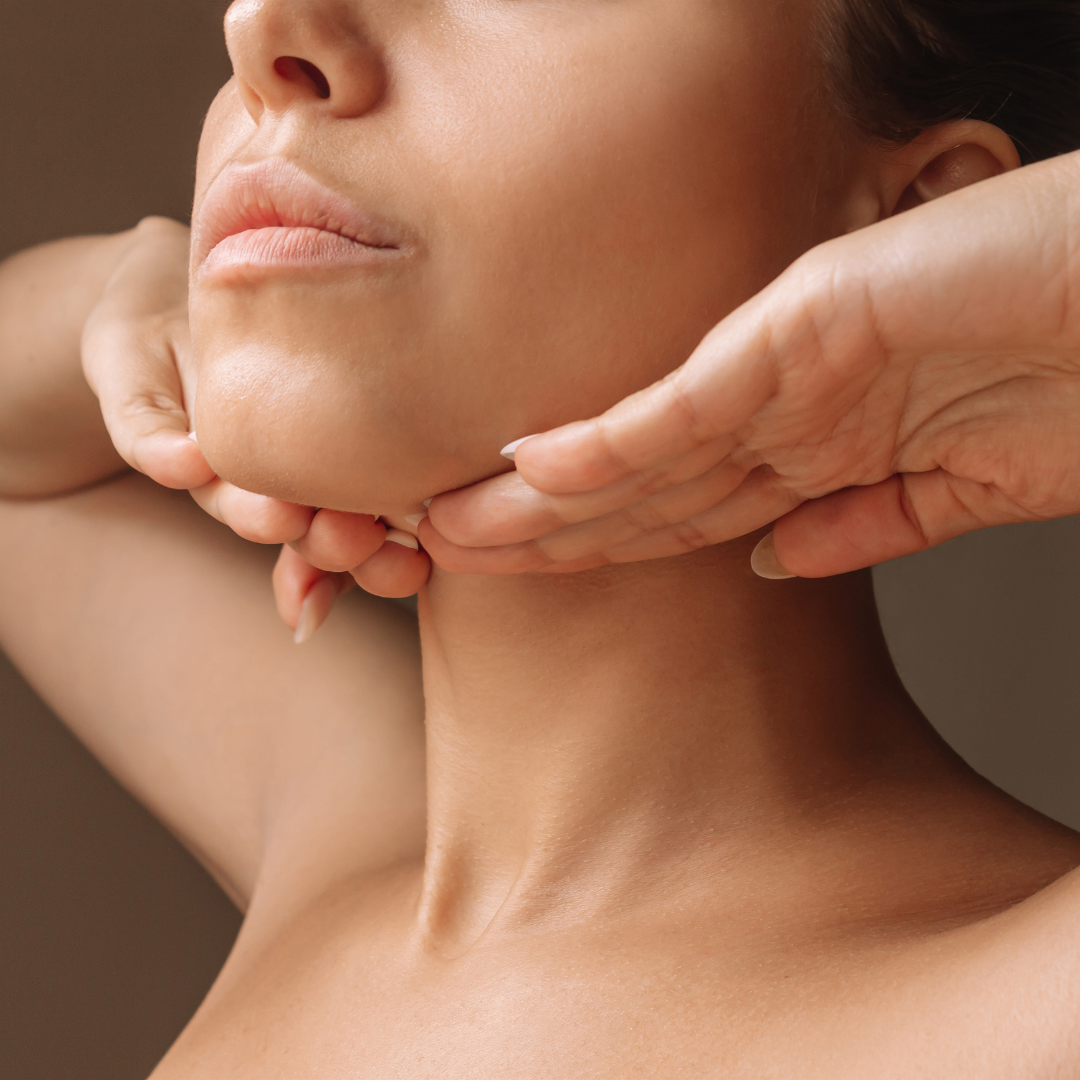 Woman doing a lymphatic drainage massage under her jaw